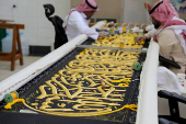 Workers prepare the Kiswa, a silk cloth that covers the Kaaba, ahead of the annual hajj pilgrimage