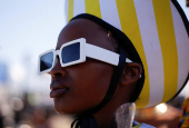 A model takes part in a fashion competition during the Durban July horse race in Durban