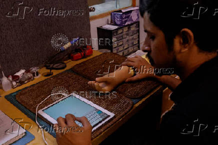 Technician checks a prosthetic limb at the Bioniks Private Limited, in Karachi