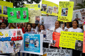 Family members of migrants imprisoned in El Salvador protest outside the United Nations building, in Caracas