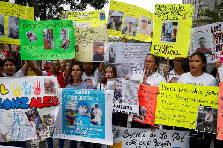 Family members of migrants imprisoned in El Salvador protest outside the United Nations building, in Caracas