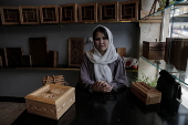 Afghan girl teach Nuristani wood carving skills at a workshop in Kabul