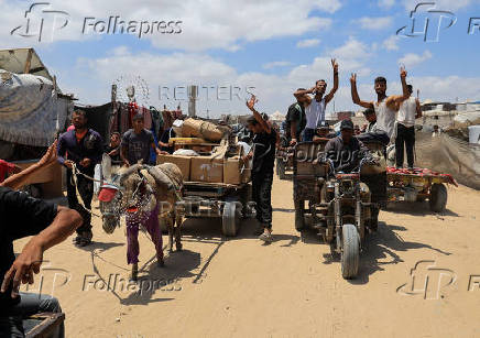 Palestinians carry aid supplies they received from the U.S.-backed Gaza Humanitarian Foundation, in Khan Younis