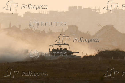 FILE PHOTO: An Israeli tank manoeuvres in Gaza