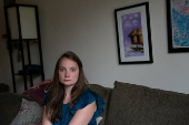 Anna Culbertson, a former employee at the National Institute of Allergy and Infectious Diseases, sits for a portrait in Bethesda, Maryland