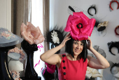 Milliner Merve Bayindir wears one of her hat creations as she speaks to Reuters ahead of the Ascot horse racing festival, in London