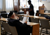 A man reads a book inside the Jewish synagogue in Larnaca