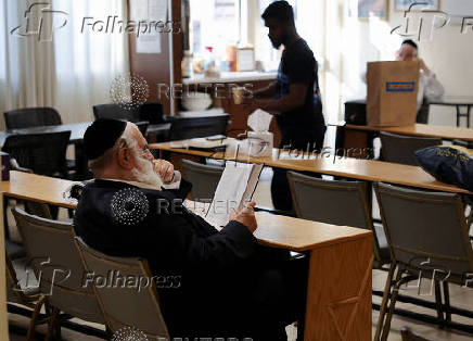 A man reads a book inside the Jewish synagogue in Larnaca