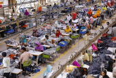 Bangladeshi garment workers sew at a textile factory in Gazipur