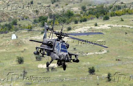 A Greek Apache helicopter flies as NATO holds training exercise 'Immediate Response' drills with host nations Albania, Bulgaria, Croatia, Greece, Kosovo, Montenegro, and North Macedonia, at Krivolak army base