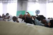 Muslim pilgrims hurl stones during 'stoning of the devil' ritual, in Mina
