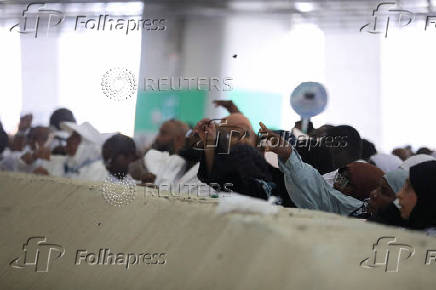 Muslim pilgrims hurl stones during 'stoning of the devil' ritual, in Mina