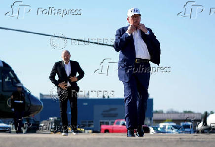 U.S. President Donald Trump and U.S. Secretary of Commerce Howard Lutnick walk at Morristown Airport