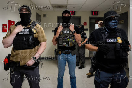 A migrant is detained by federal immigration officers at U.S. immigration court