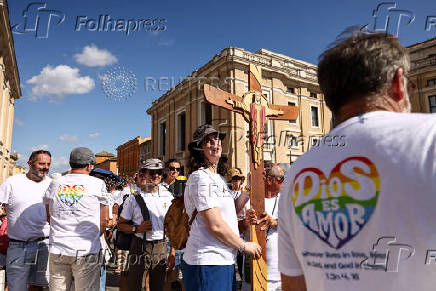 LGBTQ+ pilgrims walk towards St. Peter's Basilica