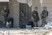Palestinians carry their belongings after Israel's decision to demolish their homes in Nur Shams camp