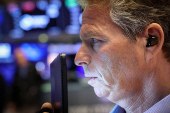 Traders work on the floor of the NYSE in New York