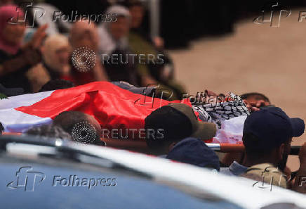 Mourners take part in the funeral of of Sayfollah Kamel Musallet, killed amid the Israel-Gaza conflict, near Ramallah
