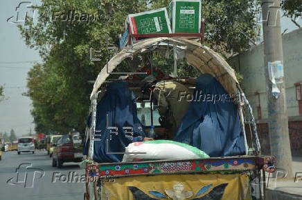 Afghan families, returned from neighboring Pakistan, receive food rations distributed by the Tawheed Charity Foundation in Jalalabad