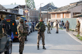 Indian security force personnel stand guard near the site of a fighter jet crash in Wuyan