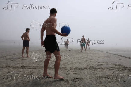People enjoy the beach in West Wittering