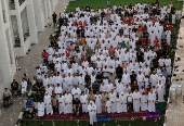Palestinians from Gaza attend Eid al-Adha prayers, at Al Thumama Complex,  in Doha