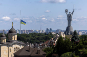 Ukrainian national flag flies at half-mast near the Ukrainian Motherland Monument after Tuesday?s deadly Russian missile strike in Kyiv
