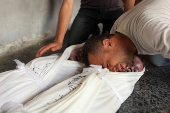 Mourners react near the bodies of Palestinians killed in an Israeli strike, in Gaza City