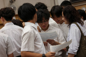 Secondary school students react after receiving their Diploma of Secondary Education (DSE) exam results in Hong Kong