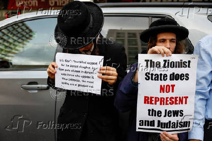 People take part in a protest against what organizers call 
