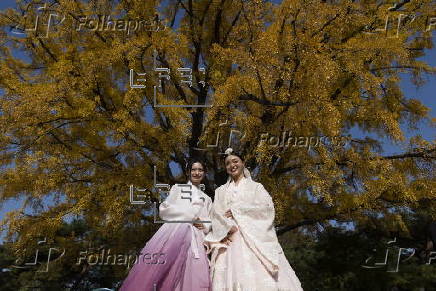 Tourists in Hanbok take selfies at Seoul’s Gyeongbokgung Palace