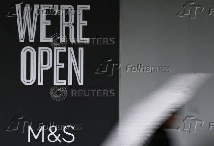 A person walks past a branch of Marks & Spencer (M&S) food outlet in London