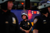 Law enforcement officers stand guard outside the U.S. immigration court at the Jacob K. Javits Federal Building during a protest against federal immigration sweeps in New York