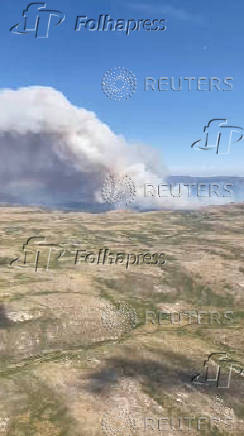 An aerial view shows smoke rising from a wildfire in Navaluenga