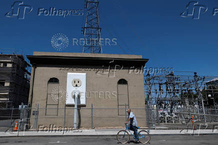 A giant electrical outlet is displayed at a PG&E substation building in Petaluma, California