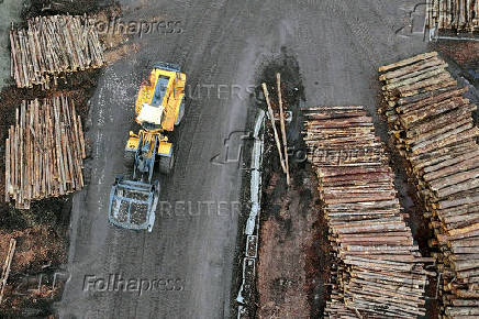 A drone view of a loader moving past cut logs outside the sawmill facility at Gorman Bros. Lumber Ltd. in West Kelowna