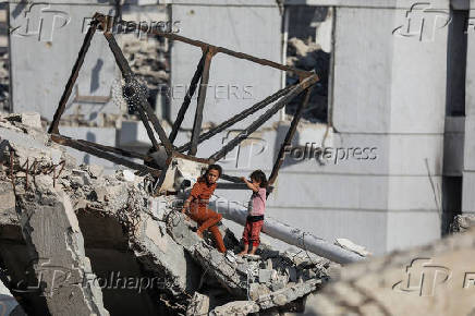 Palestinians, displaced by the Israeli military offensive, shelter in a tent camp, in Gaza City