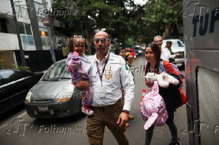 Migrants gather outside the Venezuelan embasssy waiting for a flight back to their country