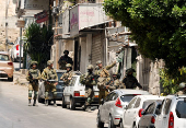 Israeli soldiers take part in a Israeli raid in Nablus