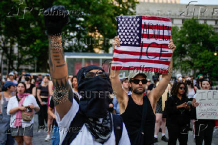 People protest against federal immigration sweeps, near the U.S. immigration court at the Jacob K. Javits Federal Building, in New York