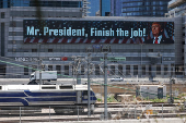 U.S. President Trump appears on giant billboards, in Tel Aviv