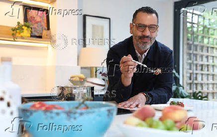 Palestinian-British chef Tamimi poses for a portrait during an interview with Reuters at his home in London