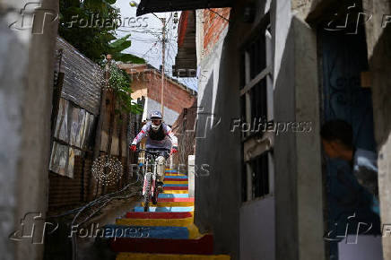 Venezuelan cyclists race downhill on a bicycle path in a Caracas suburb