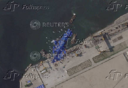 A satellite image shows a North Korean warship covered with a blue tarp after an accident that occurred during its launch at the shipyard in Chongjin