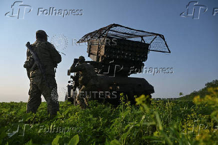 Ukrainian servicemen prepare a multiple rocket launcher before firing towards Russian troops on a front line in Zaporizhzhia region