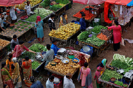 FILE PHOTO: FILE PHOTO: FILE PHOTO: Customers buy fruits and vegetables at an open air evening market in Ahmedabad