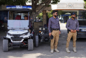 Members of Syrian Tourism Police stand guard along a street in Latakia