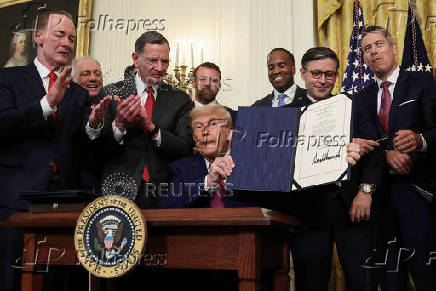 U.S. President Trump signs a resolution at the White House