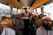 Iranian pilgrims sit in a bus at the Arar border crossing