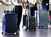 Travelers with their luggage at Schiphol Airport near Amsterdam